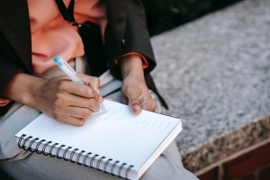 HR manager writing list of complaints from staff when they're booking leave with many employers